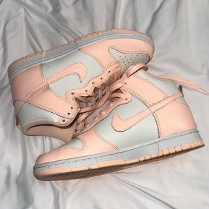 Women’s Nike Dunk Hightop’s in the color “Crimson.”